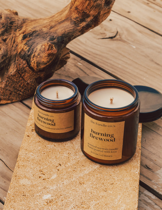 open scented candles on a wooden plank
