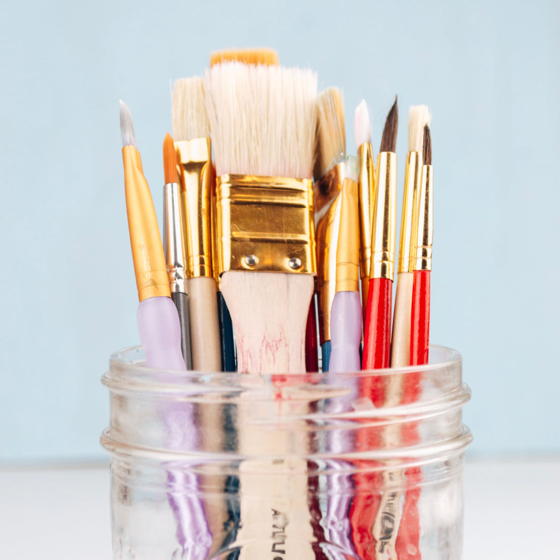 paint brushes in clear jar